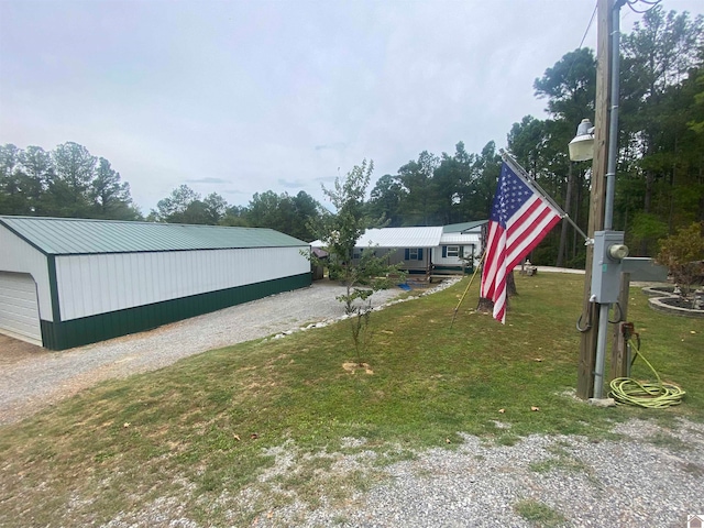 view of yard with an outdoor structure and a garage