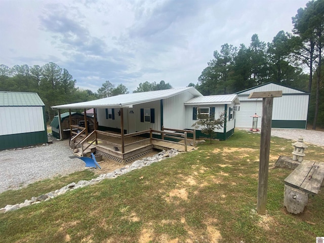 exterior space featuring a front yard, a storage unit, and a deck