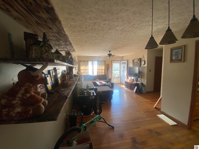 hall featuring a textured ceiling and hardwood / wood-style floors