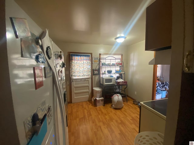 kitchen with white refrigerator and light wood-type flooring