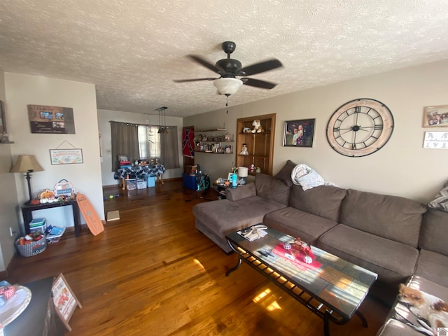 living room featuring ceiling fan, hardwood / wood-style flooring, and a textured ceiling