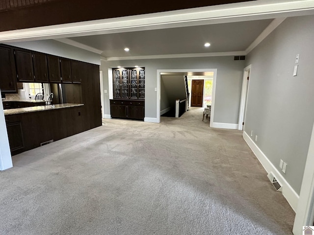 unfurnished living room with recessed lighting, visible vents, light carpet, and baseboards