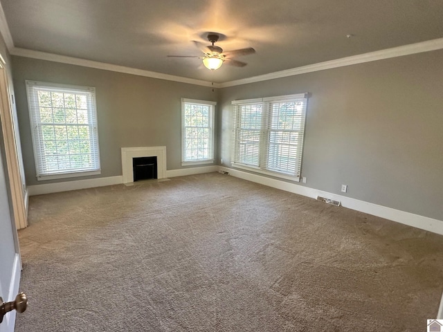 unfurnished living room featuring a fireplace with flush hearth, carpet, crown molding, and baseboards