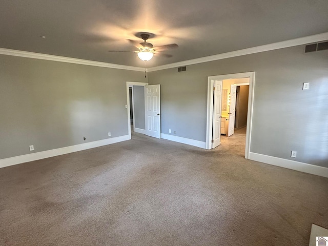 unfurnished bedroom featuring crown molding, carpet, visible vents, and baseboards