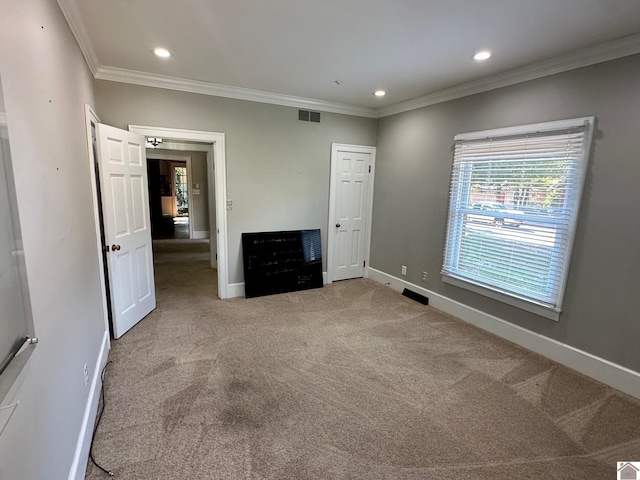 unfurnished bedroom with carpet, crown molding, recessed lighting, visible vents, and baseboards