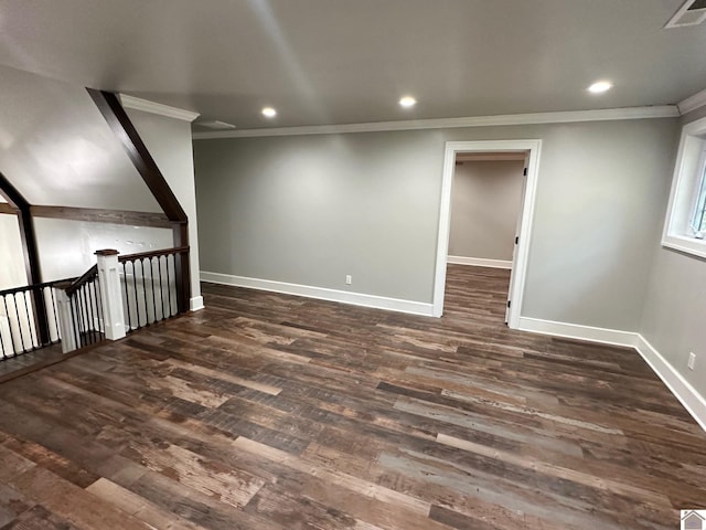 interior space with baseboards, visible vents, dark wood finished floors, and crown molding