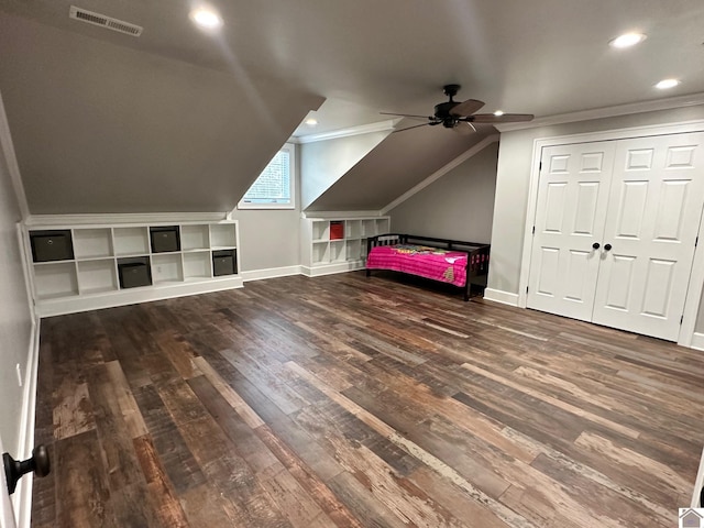 interior space featuring vaulted ceiling, ceiling fan, wood finished floors, and visible vents