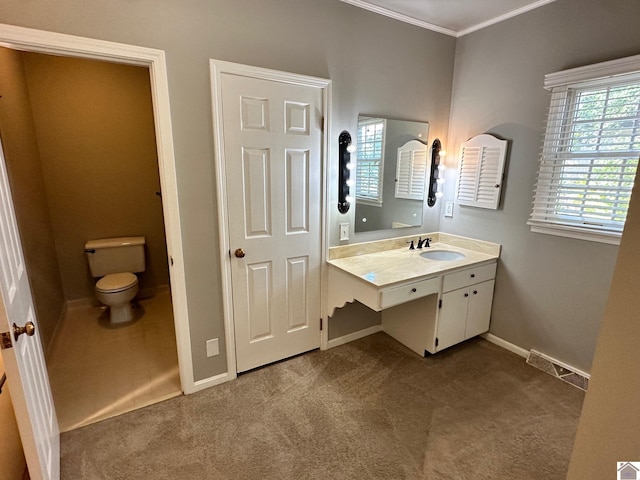 bathroom with baseboards, visible vents, toilet, crown molding, and vanity