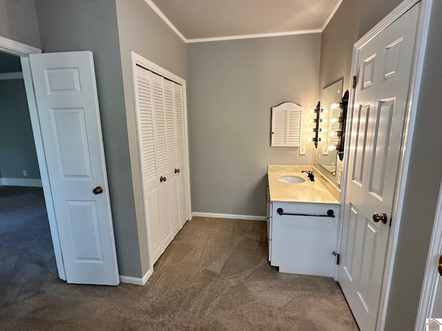 bathroom featuring carpet floors, baseboards, crown molding, and vanity