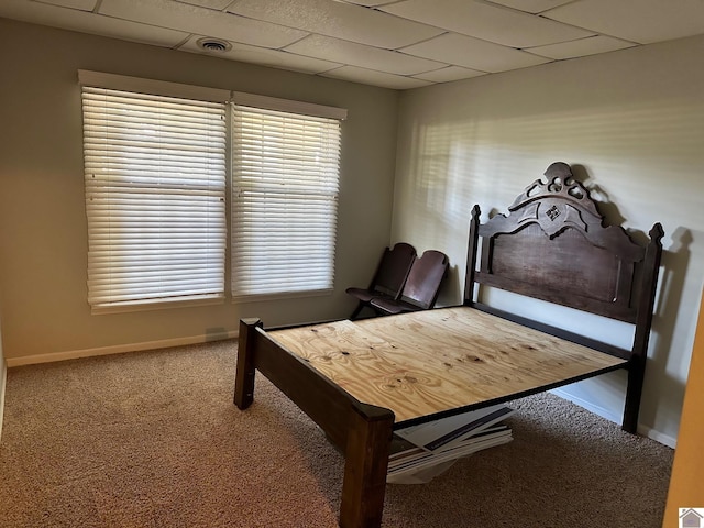 bedroom featuring carpet flooring, visible vents, baseboards, and a drop ceiling