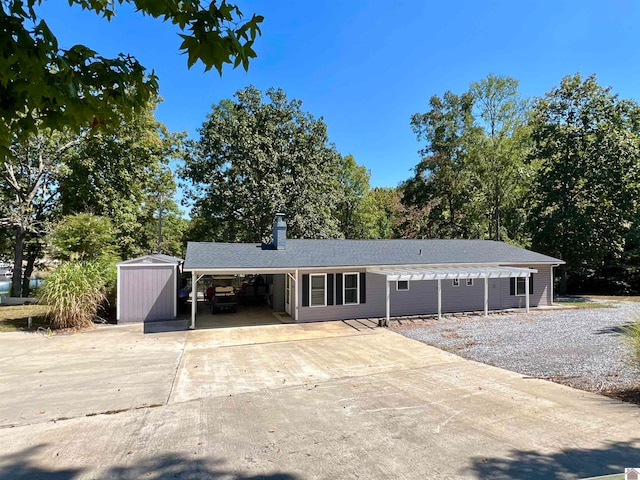 ranch-style house featuring a storage shed