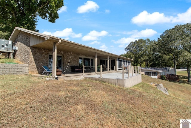 back of house with a yard and a patio