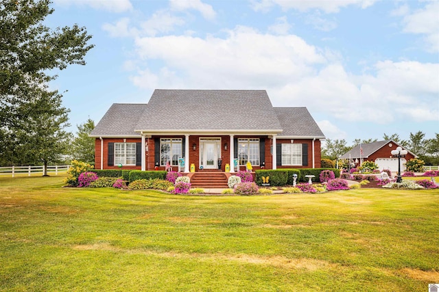 new england style home featuring a porch and a front lawn