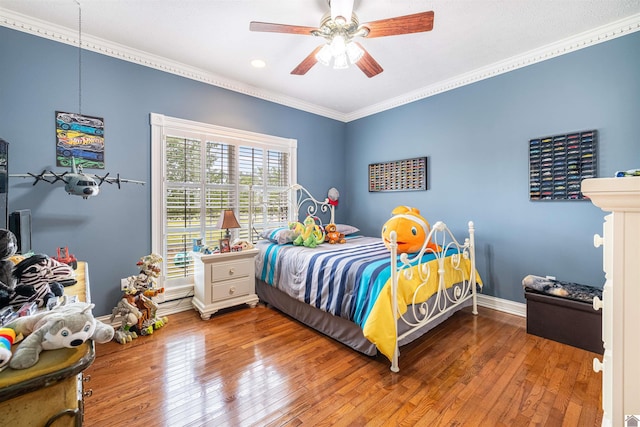 bedroom with crown molding, wood-type flooring, and ceiling fan