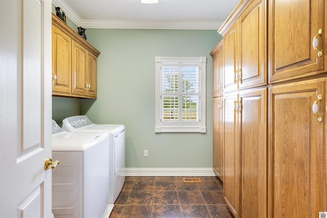 laundry room featuring crown molding, cabinets, and washer and clothes dryer