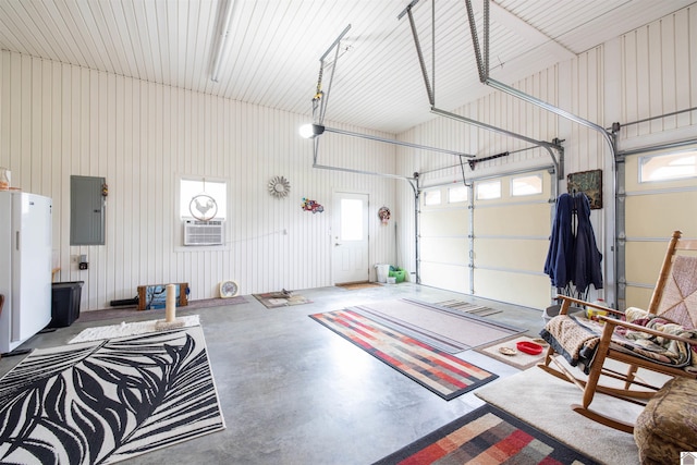 garage with electric panel and an AC wall unit