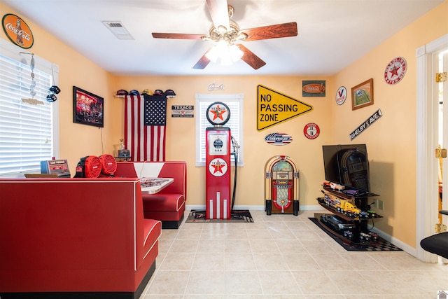 tiled living room featuring ceiling fan