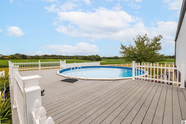 view of swimming pool with a yard and a deck