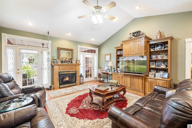 living room featuring vaulted ceiling, hardwood / wood-style flooring, and ceiling fan