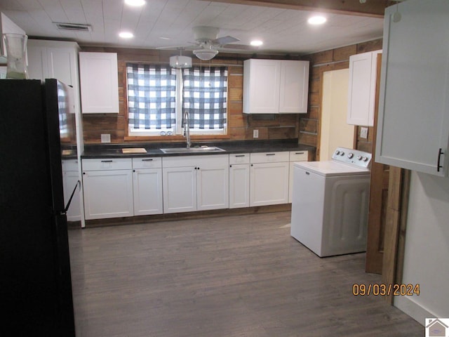 kitchen featuring black refrigerator, sink, ceiling fan, dark wood-type flooring, and washer / clothes dryer