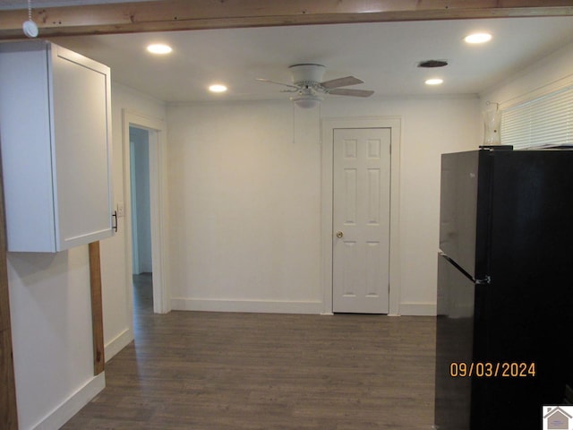 kitchen featuring dark hardwood / wood-style floors, white cabinetry, ceiling fan, and black fridge