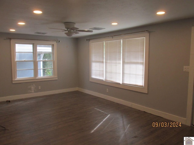 spare room featuring ceiling fan and dark hardwood / wood-style flooring