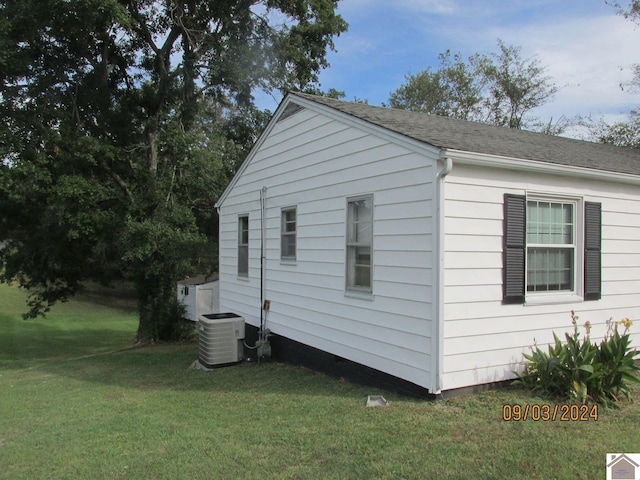 view of property exterior featuring a lawn and central air condition unit