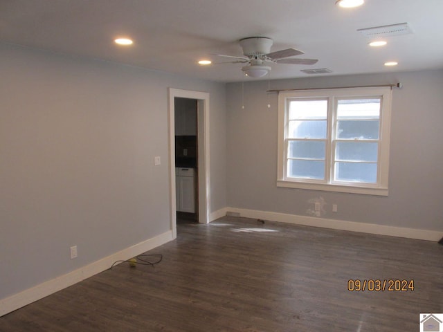 empty room featuring dark hardwood / wood-style flooring and ceiling fan