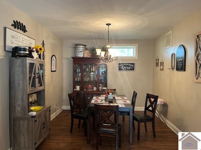 dining space with a chandelier and dark hardwood / wood-style floors