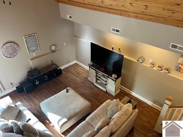 living room featuring dark hardwood / wood-style flooring and high vaulted ceiling