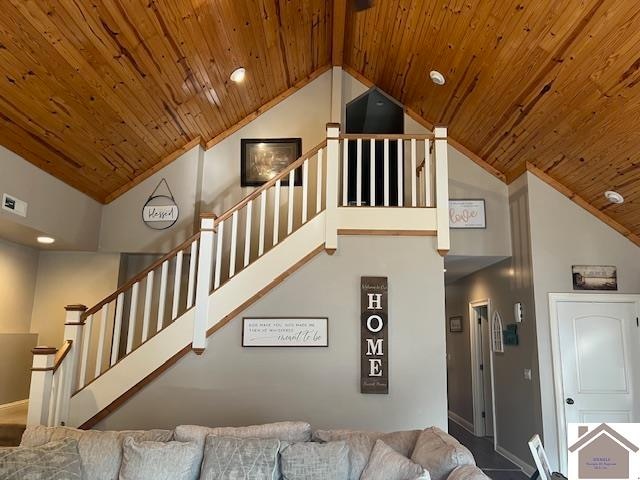 living room with high vaulted ceiling and wooden ceiling