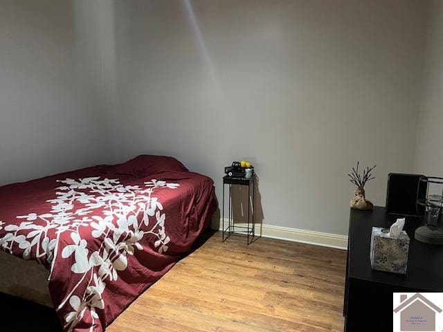 bedroom with hardwood / wood-style flooring