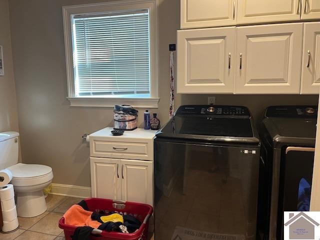 laundry area featuring independent washer and dryer and light tile patterned flooring