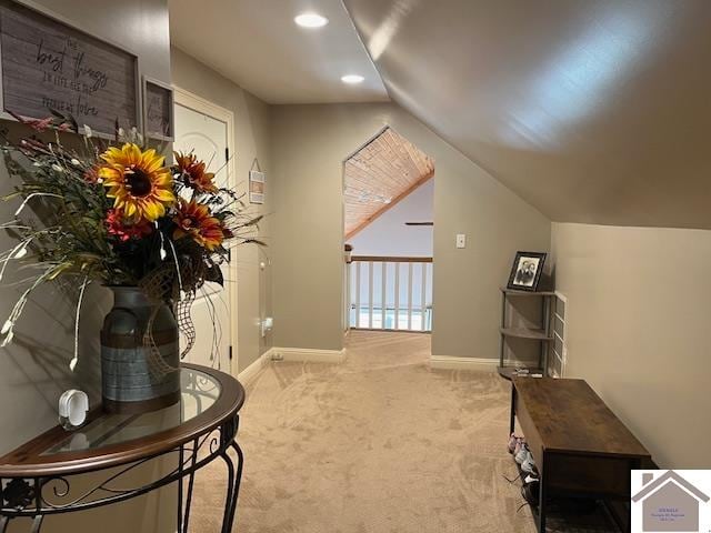 interior space featuring lofted ceiling and carpet