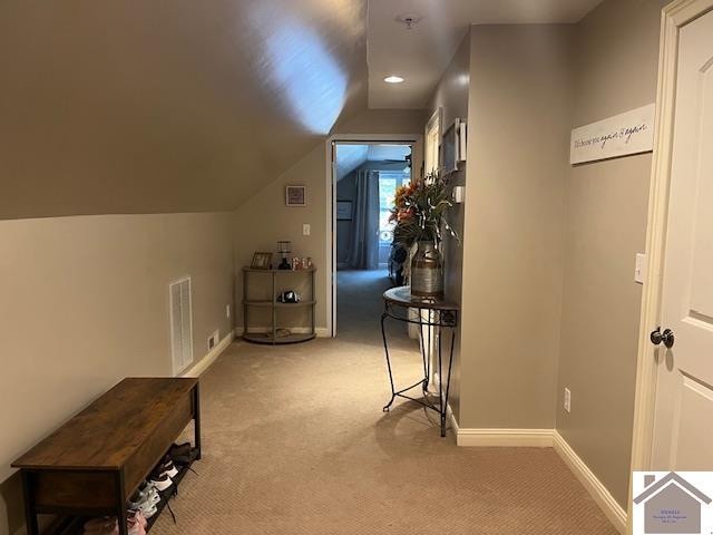 additional living space with light carpet and lofted ceiling