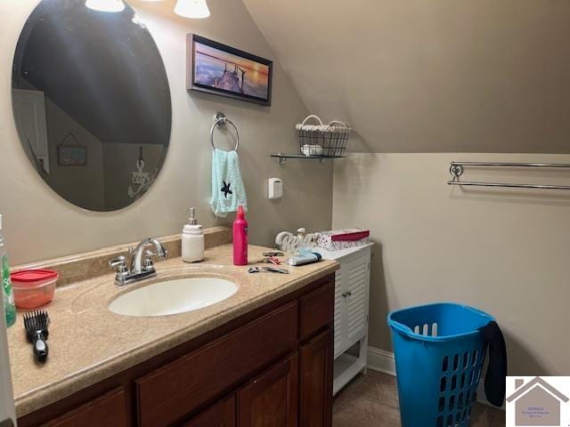 bathroom with vaulted ceiling and vanity