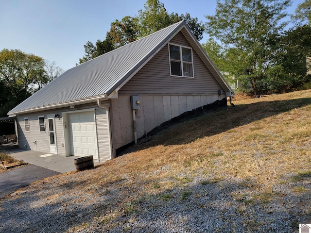 view of side of home featuring a garage