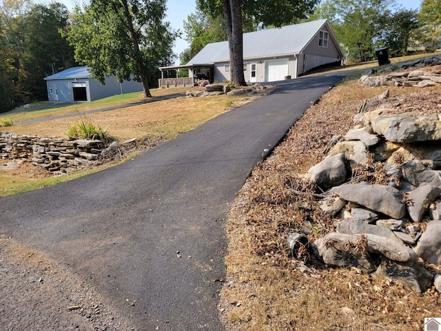 view of front of home featuring a garage, a front lawn, and covered porch