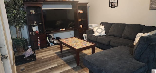 living room featuring light hardwood / wood-style flooring and decorative columns