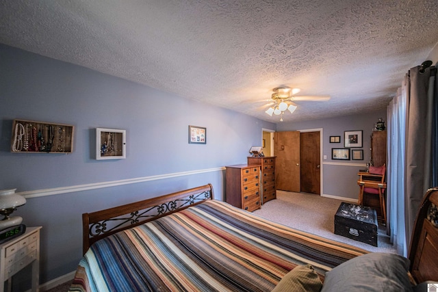 carpeted bedroom with a textured ceiling and ceiling fan