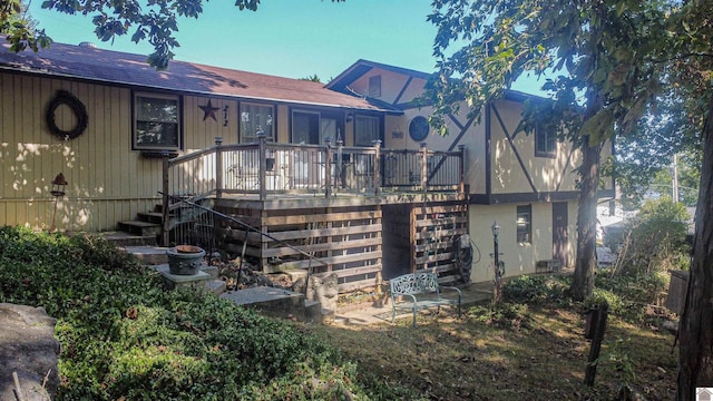 rear view of house featuring a deck