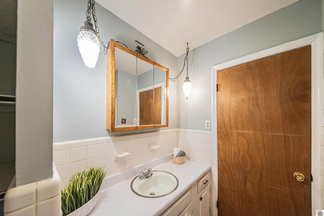 bathroom with vanity, tile walls, and decorative backsplash