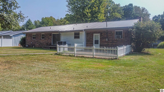 back of house with a lawn