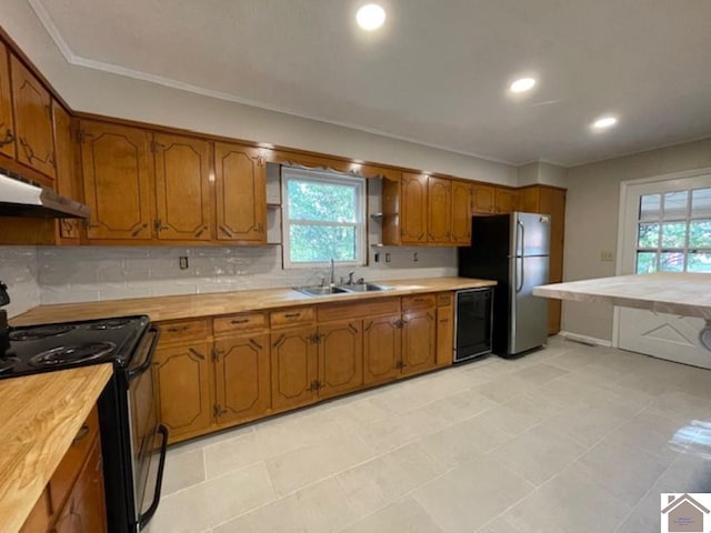 kitchen featuring backsplash, crown molding, sink, black appliances, and light tile patterned flooring