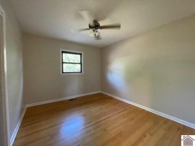 empty room featuring ceiling fan and light wood-type flooring