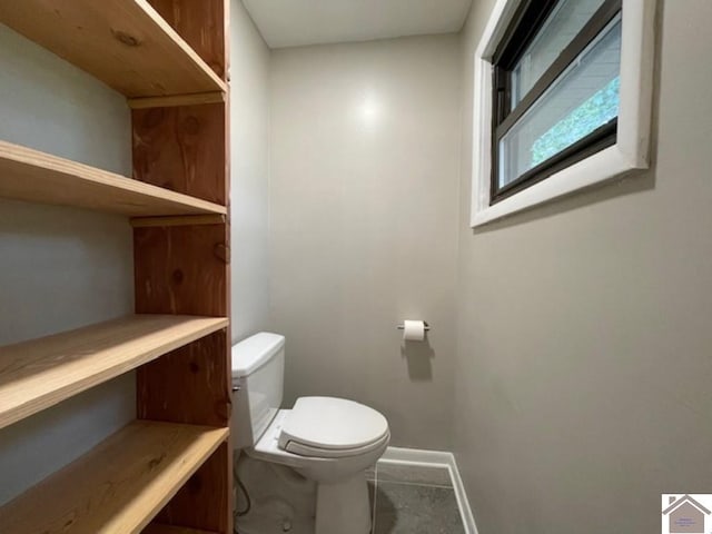 bathroom featuring toilet and tile patterned floors