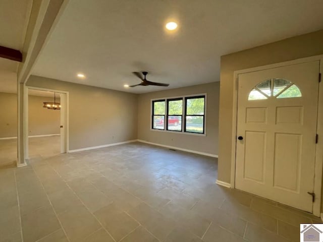 foyer with ceiling fan with notable chandelier