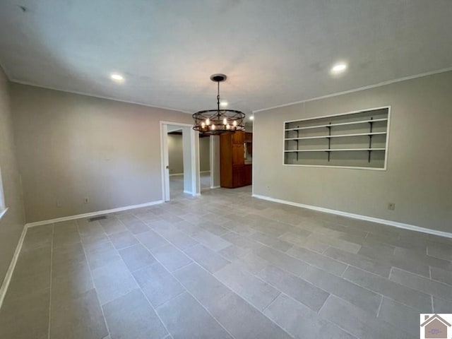 spare room featuring crown molding, built in features, light tile patterned flooring, and a notable chandelier