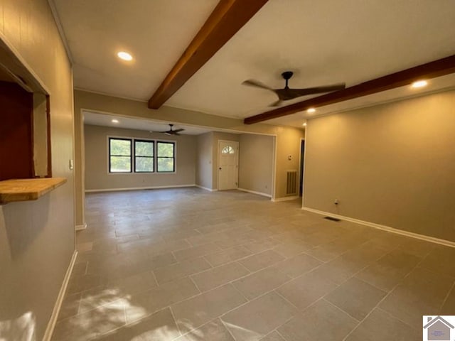 unfurnished living room featuring ceiling fan, light tile patterned floors, and beamed ceiling