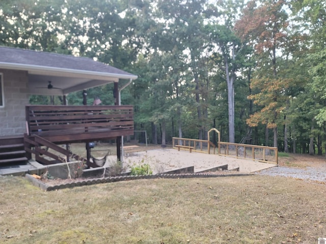 view of yard with a deck and ceiling fan